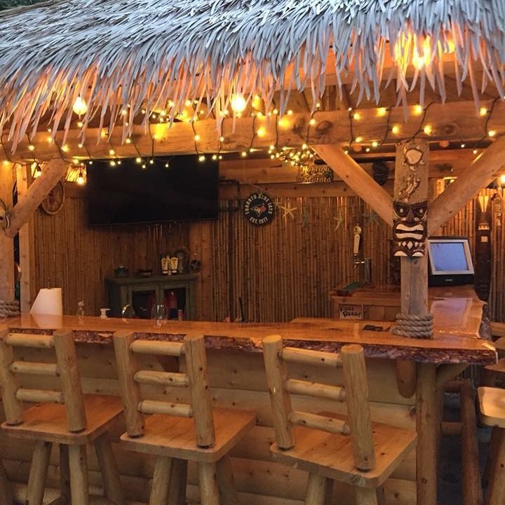 Warmly lit tiki bar at night