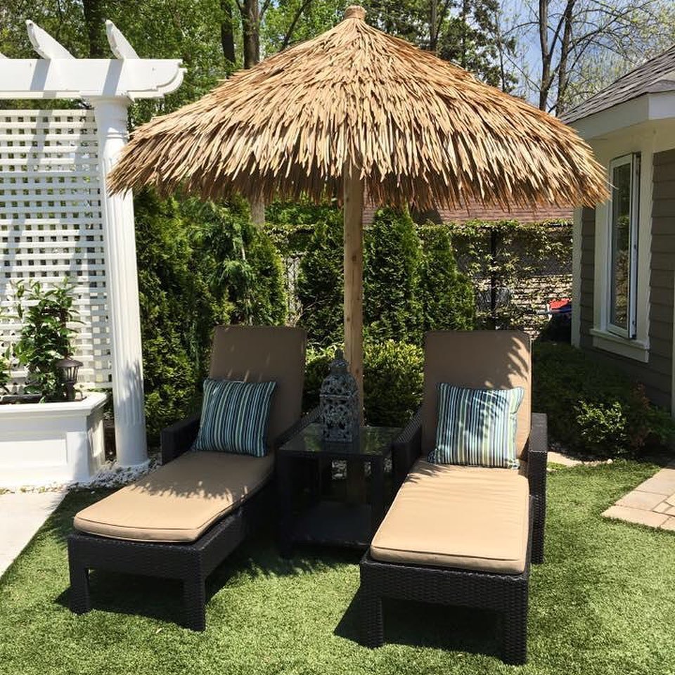 Thatched palapa shading two lounge chairs